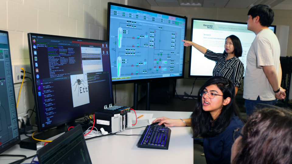 People in a lab looking at screens of data